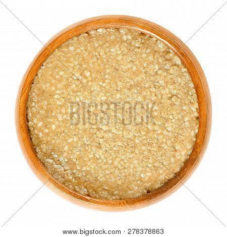 Homemade Tahini, Sesame Paste, In Wooden Bowl. Brown Condiment Made Of Ground Hulled Sesame Seeds. D