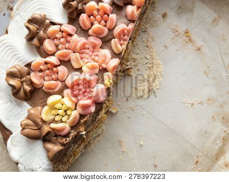 Half Part Of Meringue Cake With Flowers As Cream On The Top