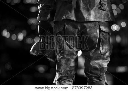 Special Unit Soldier Holds A Night Vision Device In His Hand.