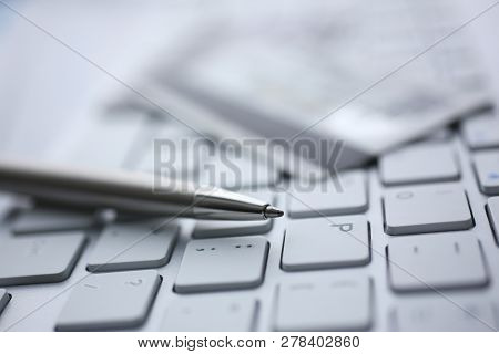 Silver Pen With Credit Card Lie White Keyboard Pc Buttons Closeup. Financial Transfer Security When 
