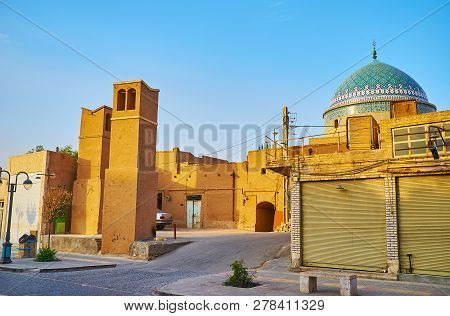 The Colorful Tile Dome Of Bogheh-ye Seyed Roknaddin Mausoleum Is Seen Behind Adobe Buildings Of Masj