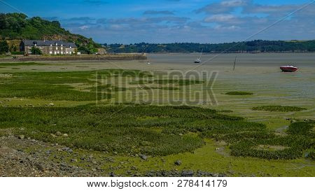House By The Sea At Low Tide Near Paimpol In Brittany, France
