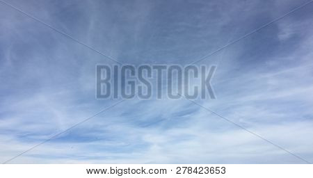 Beautiful Snowy Clouds Against A Blue Sky Background. Sky Cloud. Blue Sky With Winter Clouds Weather