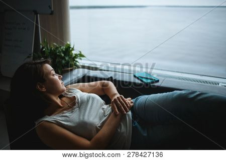 Young Business Woman Resting On The Office Couch.