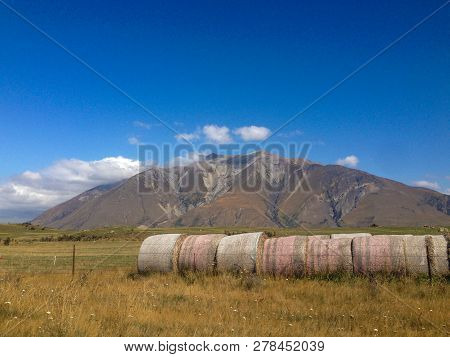 Hay Bales In Front Of Mountains On The South Island Of New Zealand