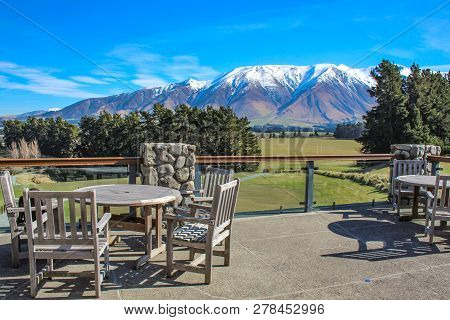 Outside Area Of Restaurant In Countryside Area, View Over Snow Capped Mountains, New Zealand