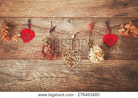Flowers Composition. Frame Made Of Dried Flowers Hydrangea, Handmade Crocheted Red Hearts On Rustic 