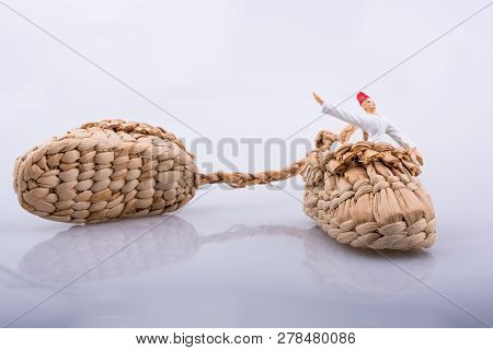 Whirling Dervish Riding In A Straw Shoe On A White Background