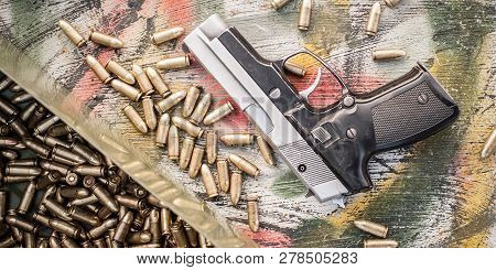 Top View Of Gun And Ammunition Box On The Table