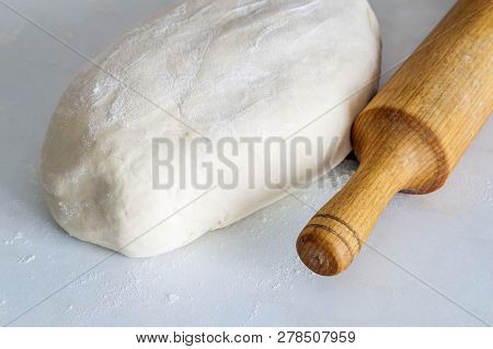 Dough Bread, Pizza Or Pie Recipe Homemade Rolling Pin Preparation On Kitchen Table. Working With Pas