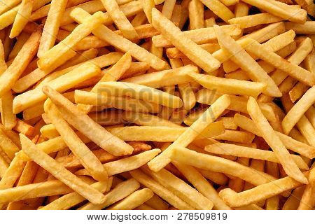 Overhead View Of Golden Deep Fried French Fries Food In Full Frame Closeup.