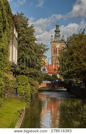 GDANSK, POLAND - AUGUST 31, 2006: The tower of St. Catherine church over the Radunia Channel. This oldest church in Gdansk was a Protestant church from 1545 until 1945, then it became a Roman Catholic
