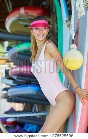 Woman With Her Surfboard At The Beach Stock Photo 