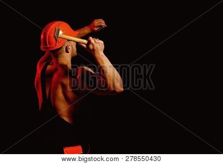 Building Under Construction. Muscular Man Builder At Work Under Construction. Man Work With Hammer. 