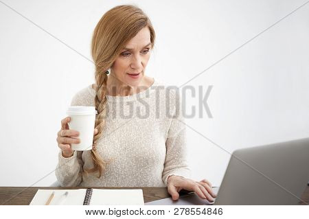Elegant Neat Elderly 60 Year Old Female Blogger In Stylish Wear Drinking Coffee Holding Disposable P