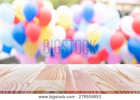 Emtry Wooden Table On Top Over Blur Balloon Background, Can Be Used Mock Up For Montage Products Dis
