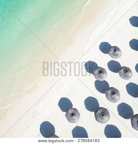 Aerial View Of Amazing Tropical White Sandy Beach With Palm Leaves Umbrellas And Turquoise Sea.