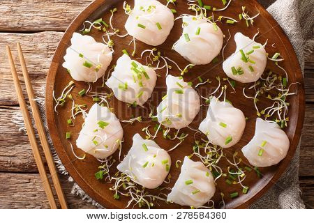 Delicious Dumplings Dim Sum With Shrimp Served With Sprouts Close-up On A Plate. Horizontal Top View