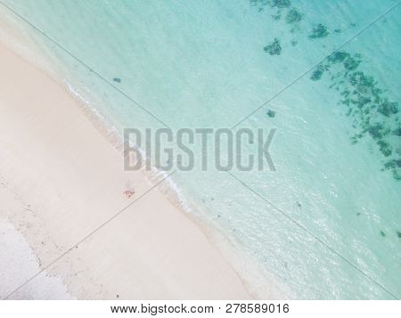 Aerial Shot Of Woman Enjoying The Picture Perfect White Tropica Beach On Mauritius Island.