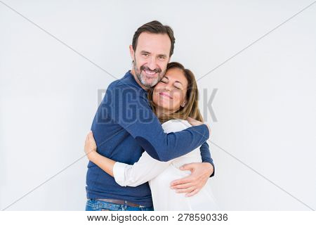 Beautiful middle age couple in love over isolated background Hugging oneself happy and positive, smiling confident. Self love and self care