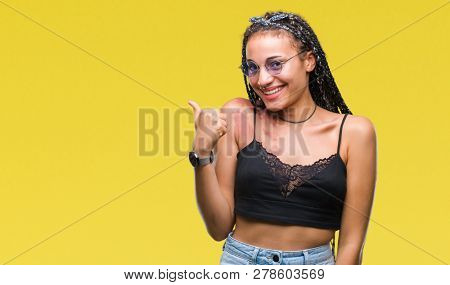 Young braided hair african american with birth mark wearing sunglasses over isolated background doing happy thumbs up gesture with hand. Approving expression looking at the camera with showing success