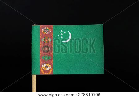 The National Flag Of Turkmenistan On Toothpick On Black Background. A Green Field With A Vertical Re