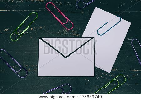 Funny Metaphor Of Inbox With Email Envelop And Attachment Clip On Real-life Desk