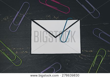 Funny Metaphor Of Inbox With Email Envelop And Attachment Clip On Real-life Desk