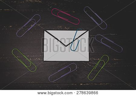 Funny Metaphor Of Inbox With Email Envelop And Attachment Clip On Real-life Desk