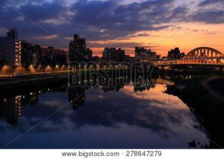 Songshan District Sunset Cityscape In Taipei. River Skyline Reflection.
