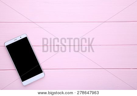 Mobile Phone With Blank Screen On Pink Wooden Table. Smartfone White