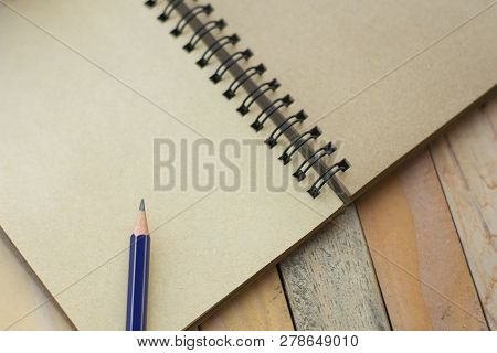 Notepad With Pencil On Wood Board Background.using Wallpaper For Education, Business Photo.take Note