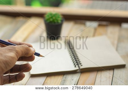 Man Business Inspection Writing Notepad With Pencil On Wood Board Background.using Wallpaper For Edu