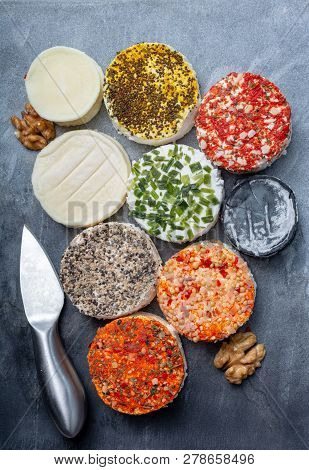 Assortment Of French Fresh White Soft Goat Cheeses With Different Tastes Topping Made With Herbs, Pa