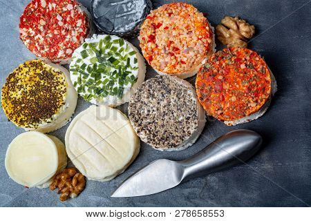 Assortment Of French Fresh White Soft Goat Cheeses With Different Tastes Topping Made With Herbs, Pa