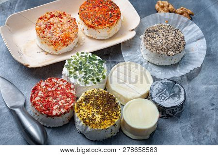 Assortment Of French Fresh White Soft Goat Cheeses With Different Tastes Topping Made With Herbs, Pa