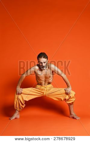 Yoga. Portrait Of Yogi Men Doing Yoga Exercise On Black Mat, He Breath And Performing Upward Abdomin