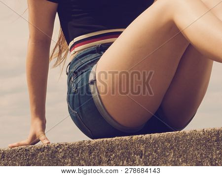 Woman Showing Her Sexy Curves. Hips And Legs Body Part In Short Denim Shorts.