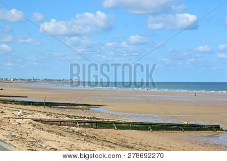 Groynes On A Sandy Beach In Normandy