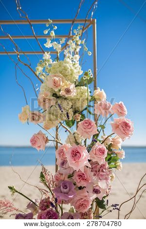 Event Decoration. Wedding Chuppa At Riverside Decorated With Fresh Flowers. Florist Workflow.