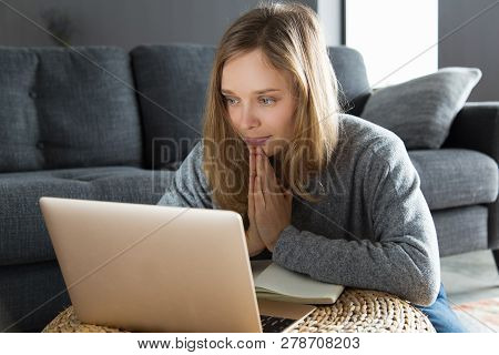 Positive Girl Having Video Call And Asking For Help. Young Woman Keeping Hands Together In Pray And 