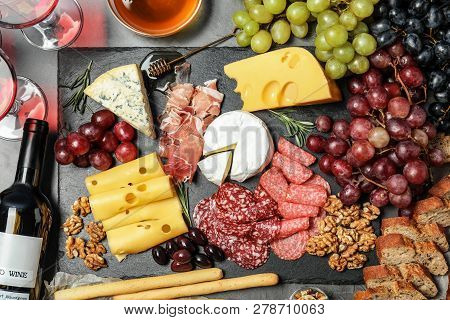 Flat Lay Composition With Wine And Snacks On Grey Background