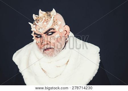 Demon On Black Background, Close Up. Man With Thorns Or Warts In Fur Coat. Alien, Demon, Sorcerer Ma