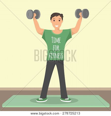 Happy Male Standing Training With Gray Dumbbell. Smiling Young Man Holding His Hand Up With Dumbbell