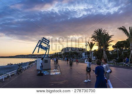 Nice, France - June 23, 2016: Tourists Enjoy Summer Night At Promenade Des Anglais In City Of Nice, 