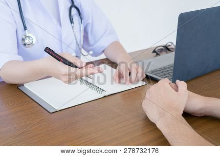 Doctor Physician Consulting With Male Patients In Hospital Exam Room. Men's Health Concept