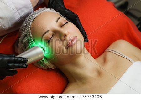 Hardware Cosmetology. Beautician Makes Ultrasonic Skin Tightening Client. Skin Pore Cleansing. Anti-