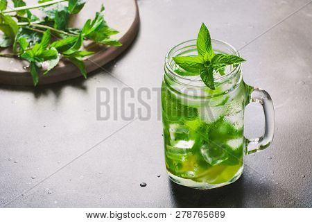 Mojito Cocktail In Mason Jar With On Black Stone Table. Copy Space For Text.