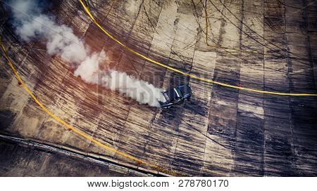Blurred Of Image Diffusion Race Drift Car With Lots Of Smoke From Burning Tires On Speed Track. Aeri