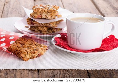 Flapjacks And Cup Of Coffee. Homemade Healthy Oat Bars With Honey And Currant. Flapjacks And Cup Of 